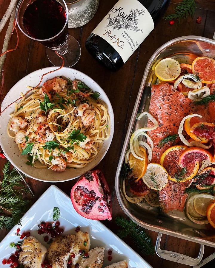 Family Style dinner with cooked copper river salmon, seafood pasta and cooked white fish