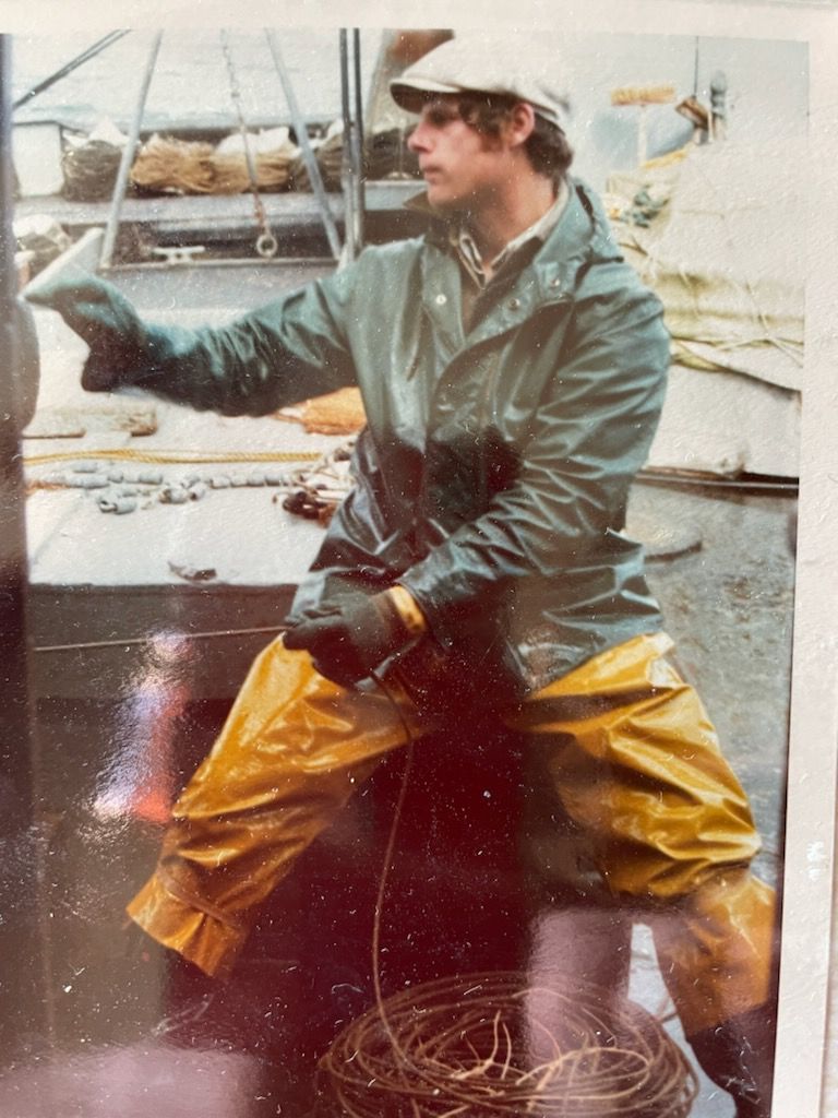 Portrait of a young Art Hodgins, Sena's Dad on board a fishing boat.