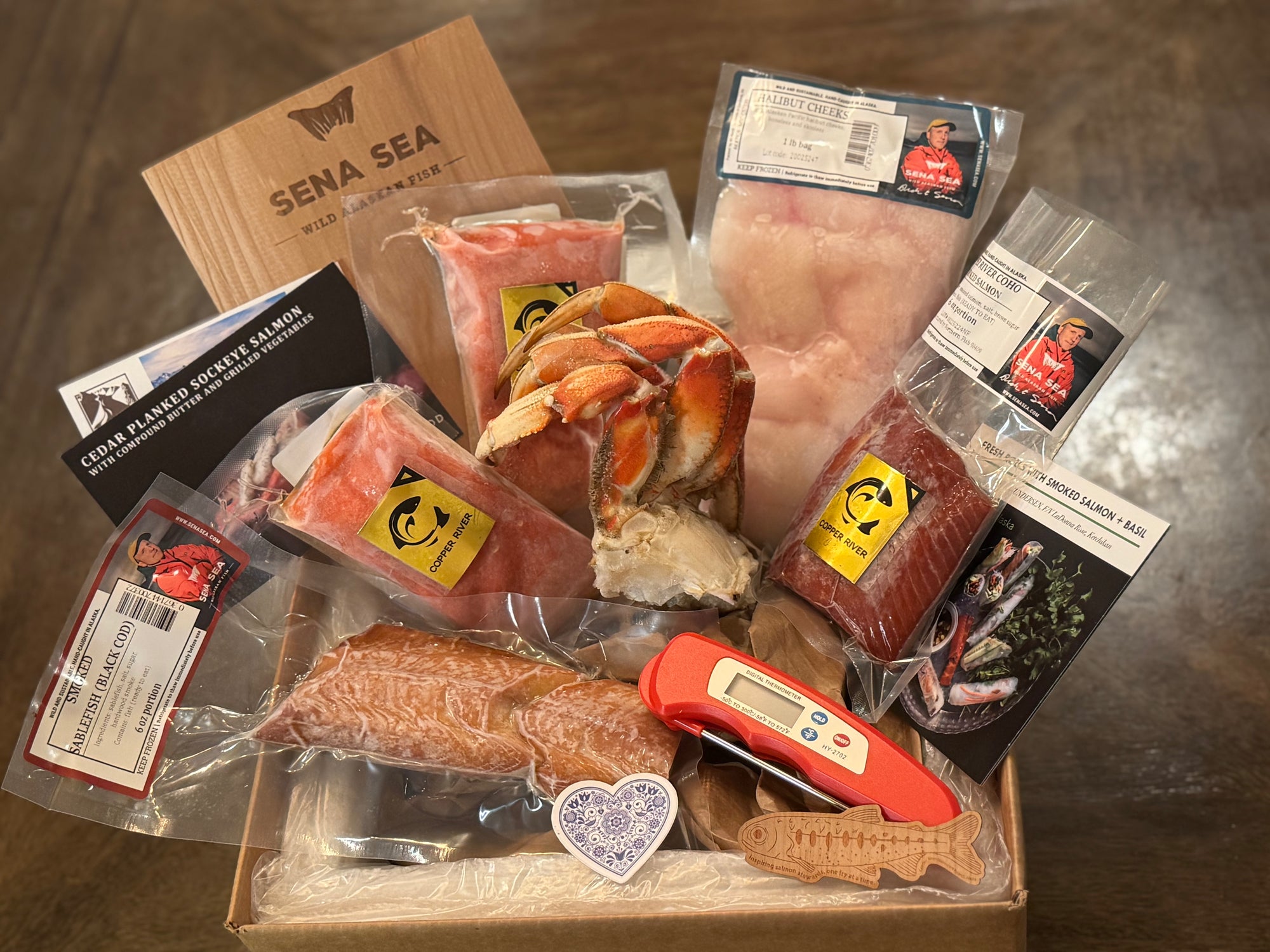 Box of packaged seafood with a digital thermometer on a wooden surface