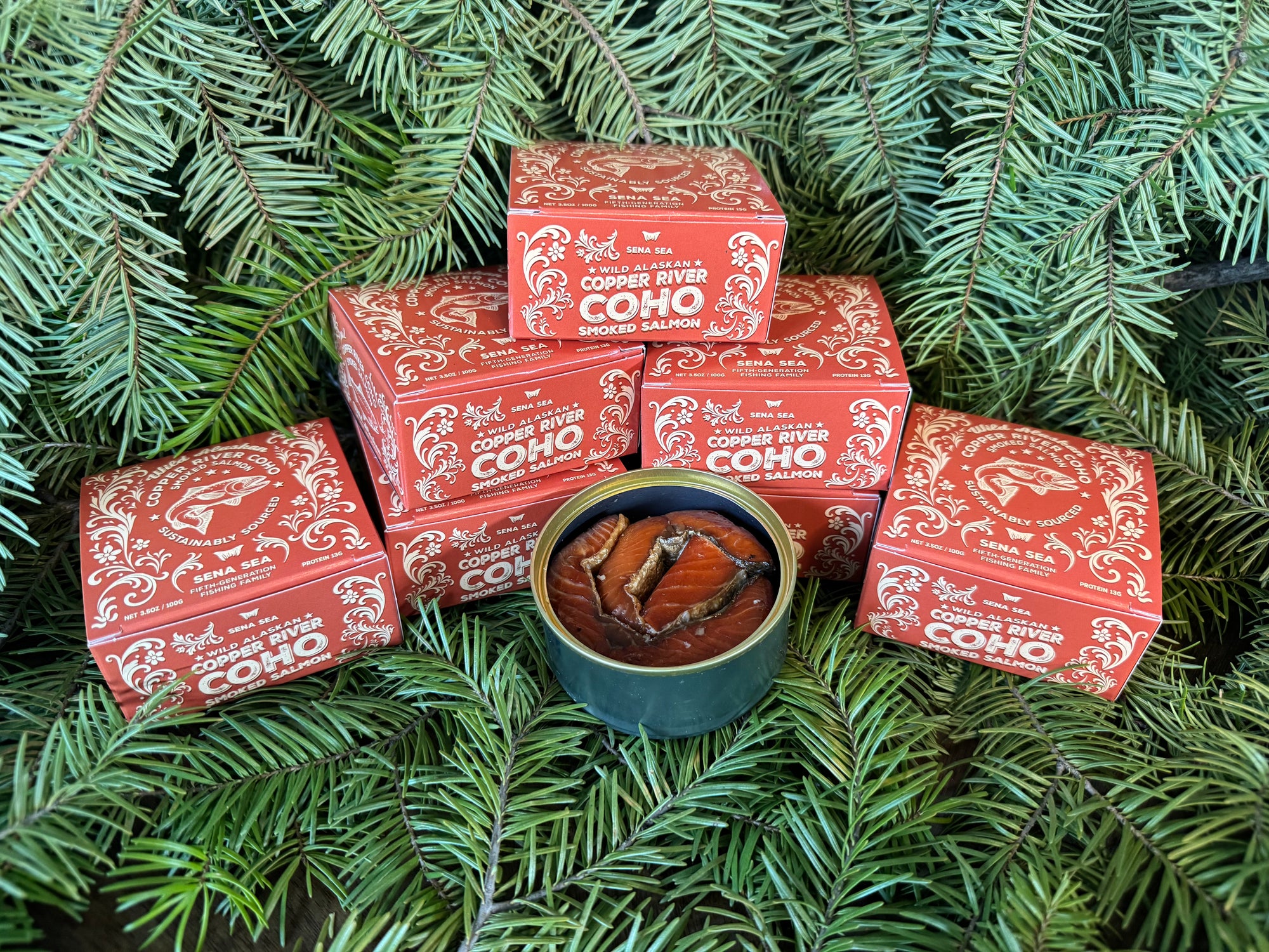 orange boxes labeled 'Copper River Coho' on a green leafy background