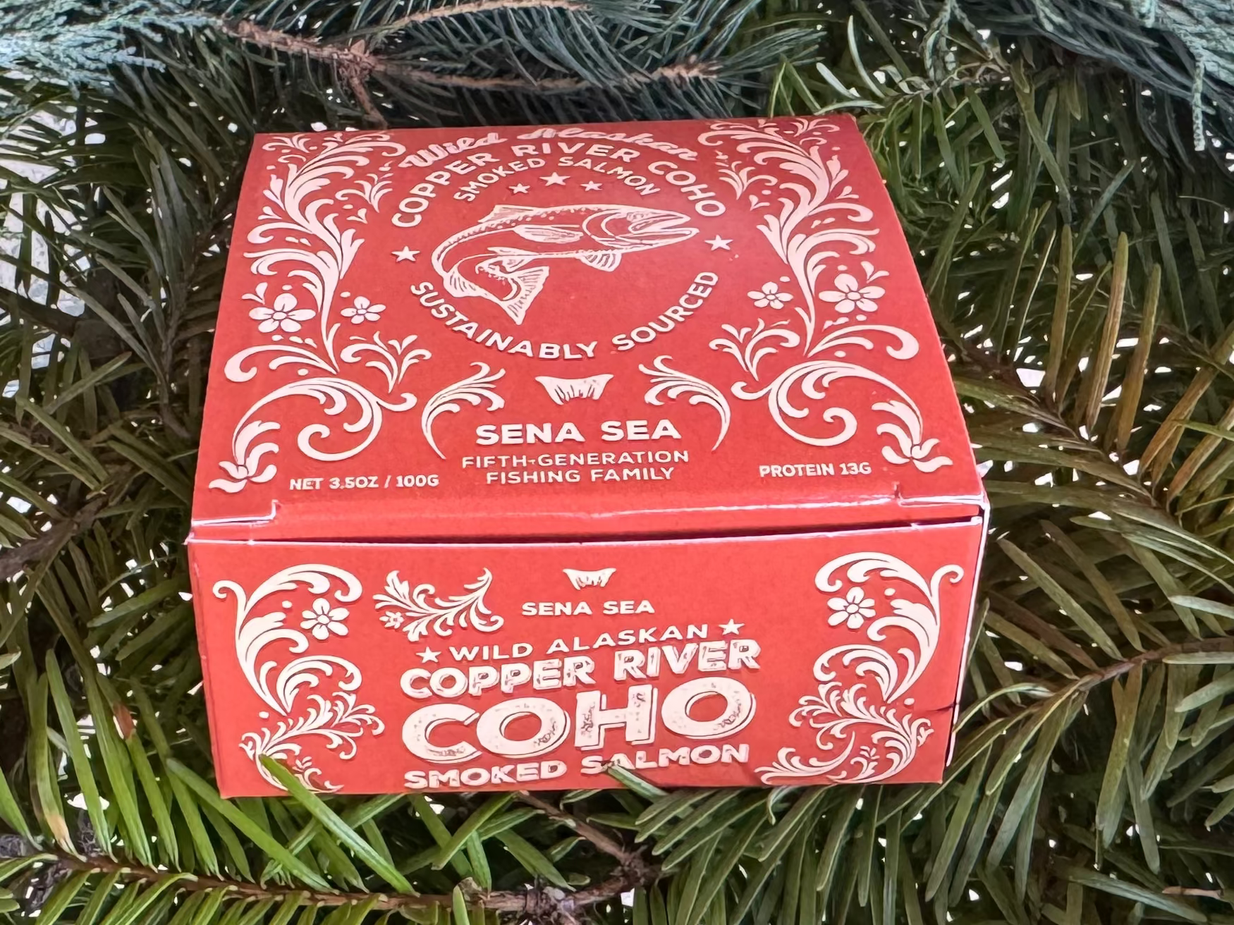 orange box of smoked copper river coho salmon on a bed of greenery