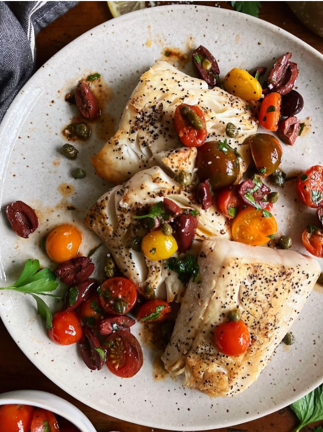 Sena Sea wild caught halibut cooked and plated with multi-colored cherry tomatoes and fresh herbs