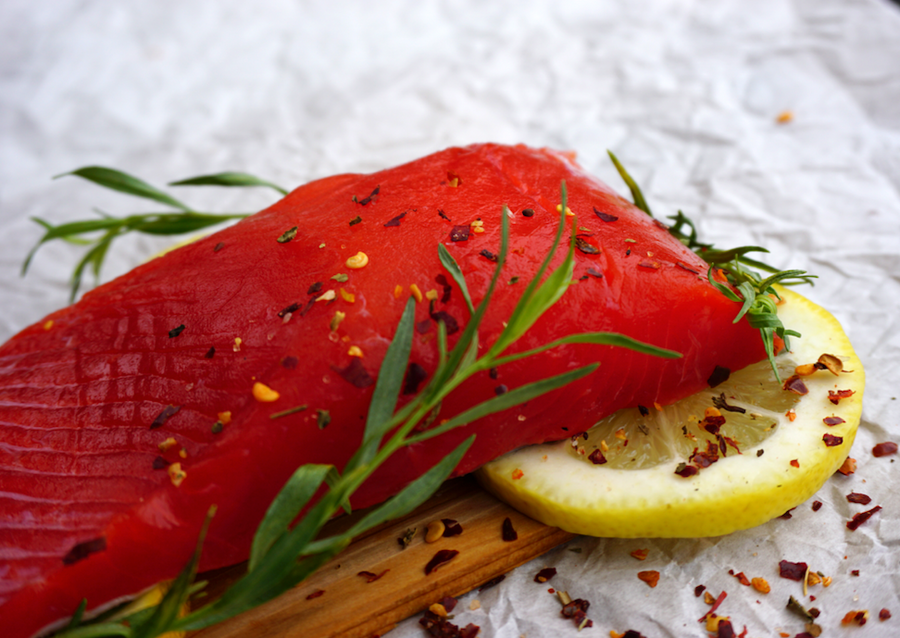 Sustainable copper river sockeye salmon on cedar plank with lemon